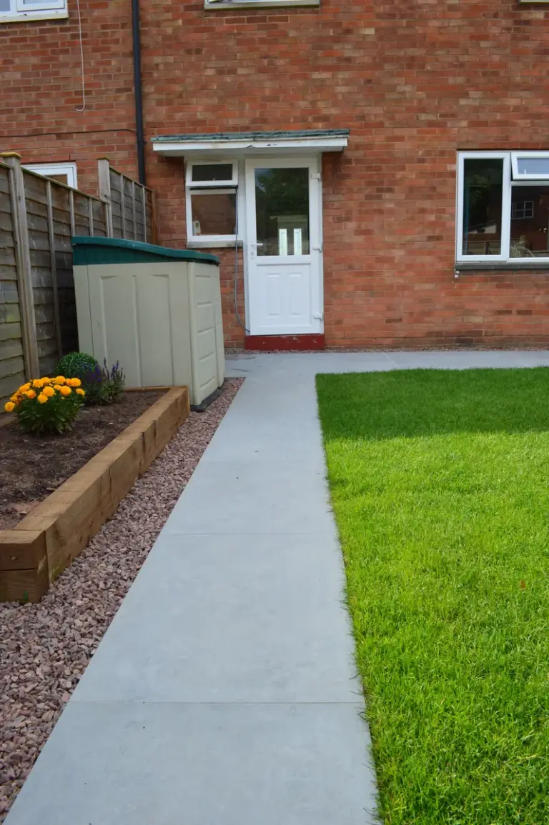 A garden patio and flowerbed.